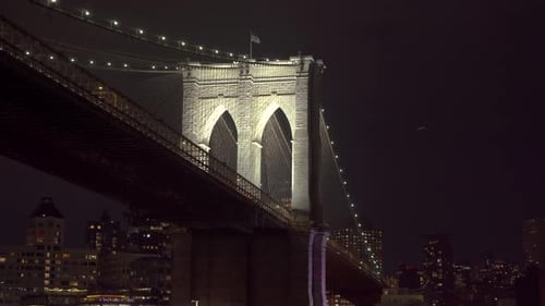 Iconic New York Brooklyn bridge at night, motion view