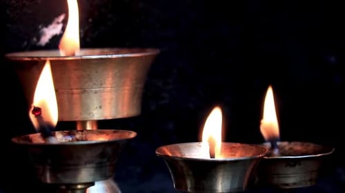 Traditional Butterlamps with fire at a monastery. Close up slow motion