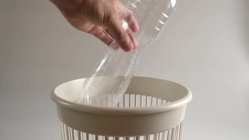 Plastic Bottle Being Recycled in a Bin