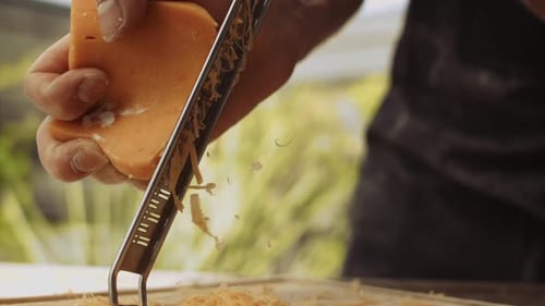 Man Grating Cheese For Pizza