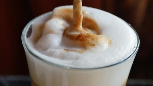 Close Up of Creamy Cappuccino Foam Being Stirred