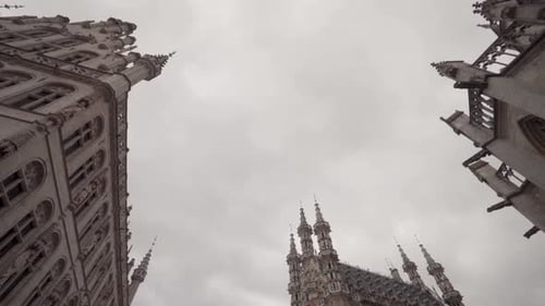 Low angle shot of gothic architectural town hall, Saint Peter's Church and guild building on the Gra