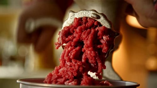 Close Up of Fresh Red Meat Emerging from a Manual Grinder
