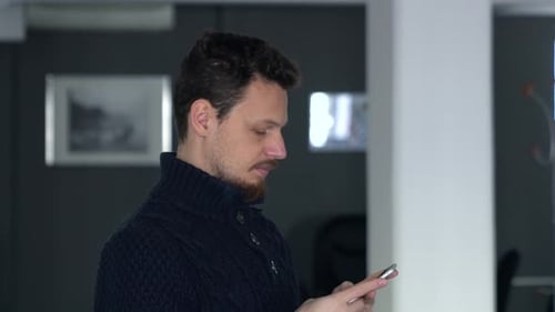 Man Using Cell Phone Indoors Close Up