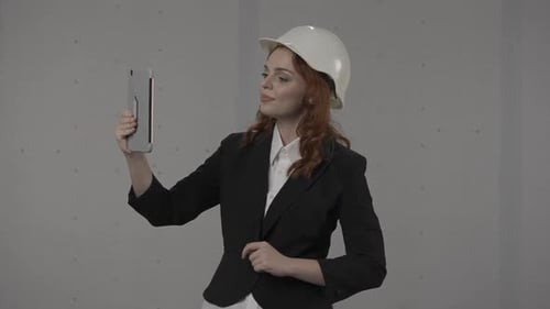 Woman Architect Talking on Tablet Video Call