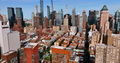 Sunny cityscape of New York from aerial view. Drone footage approaching stunning skyscrapers.