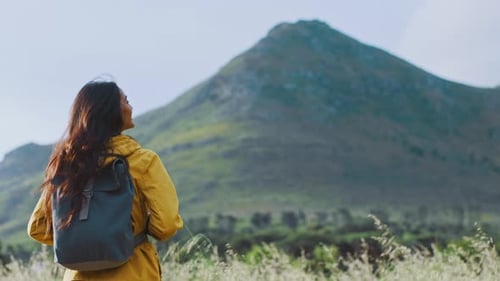 Woman, mountain and backpacking for adventure, travel or hiking journey in the countryside