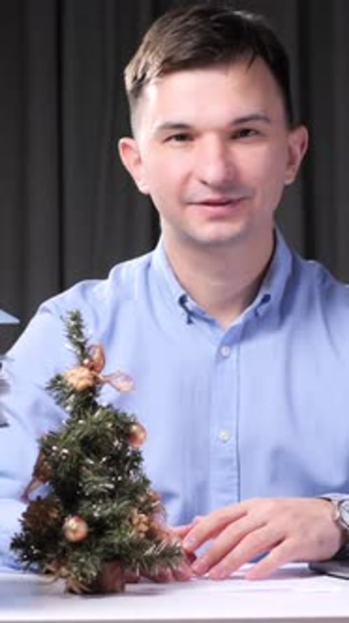 Young Adult with Miniature Christmas Tree Smiling