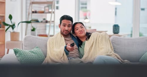 Young Couple Relaxing Together at Home Watching TV