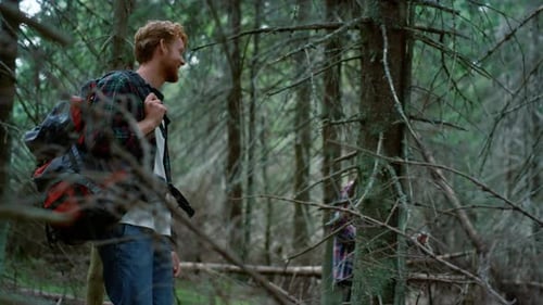 Female And Male Hikers Walking In Summer Forest. Smiling Guy And Girl Hiking In Woods Together. R...