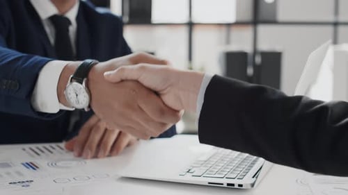 Business Professionals Shake Hands in Modern Office
