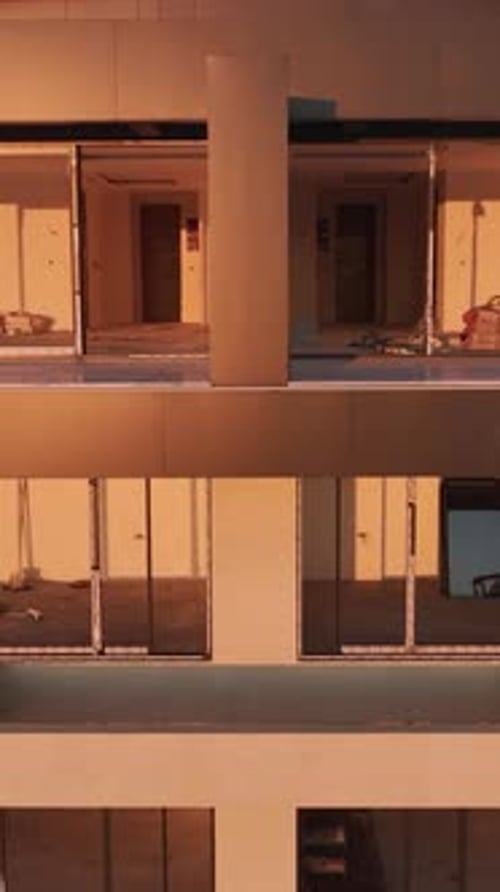 Vertical Video Aerial Perspective of a Building Facade Being Built with Scaffolding and Visible