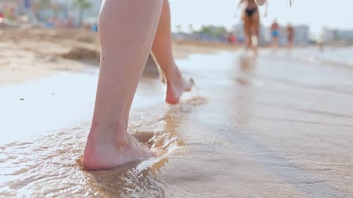 Bare Feet Walking on Sandy Beach Shoreline