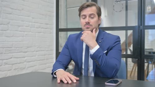 Pensive Mature Adult Businessman Thinking while at Work
