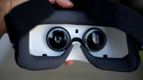 Man hand holding VR virtual reality headeset close up