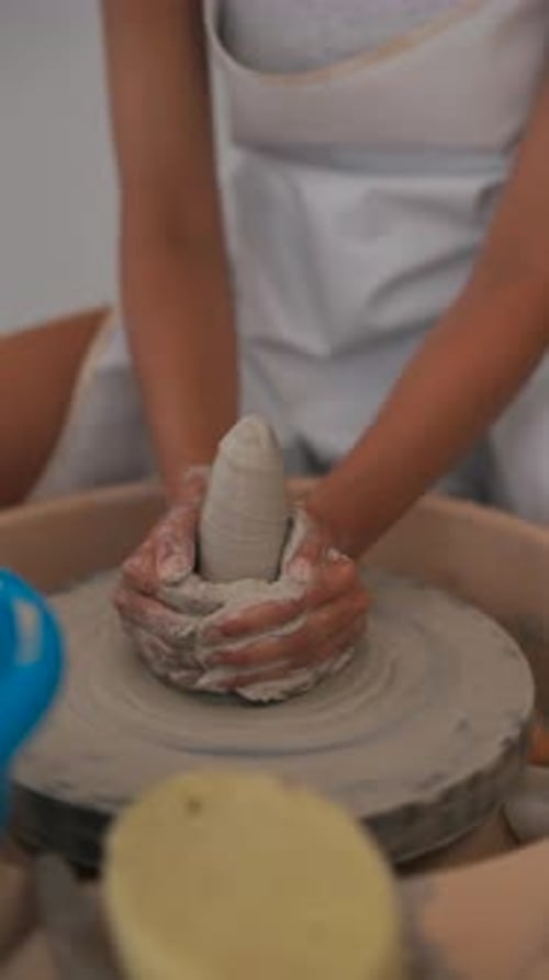 Person Shaping Clay on Pottery Wheel