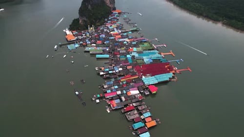 Drone shot over the Ko Panyi, revealing limestone cliffs, in Phang Nga Bay Thailand