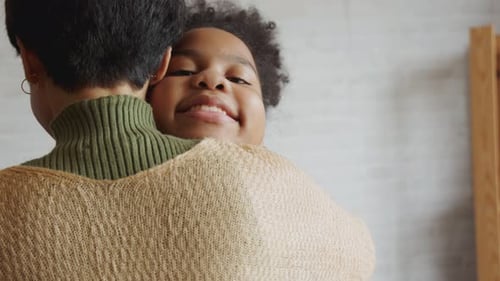 Child Hugging Adult Indoors with Affection