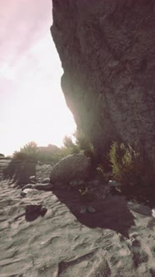 Sunset Behind a Rocky Cliff at the Beach