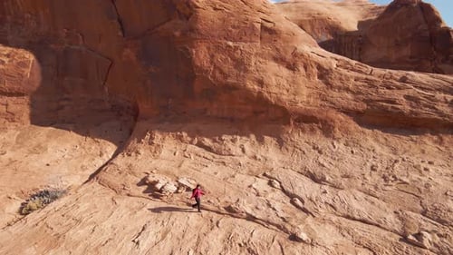 Aerial of a woman hiking through the landscape near Moab