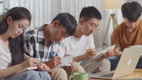 Focused Students Studying Together in a Living Room