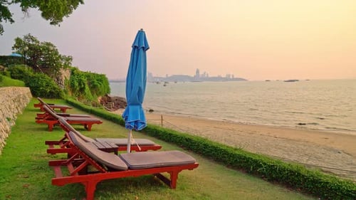 beach chair or pool bed and umbrella with sunset and sea background