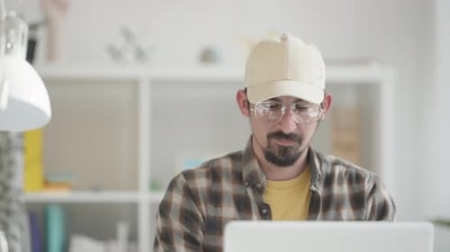 Young Adult Working on Laptop at Home