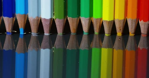 Colorful Pencils Reflected on a Glossy Surface