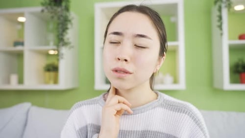Young Woman Checking for Swollen Glands