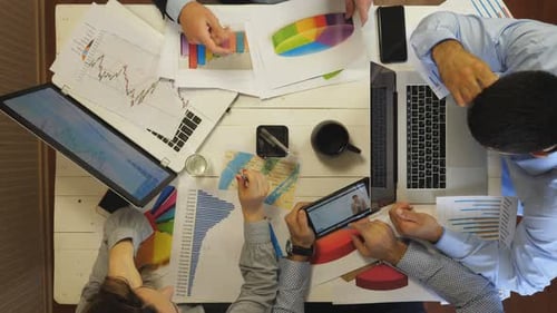 Young Tired Coworkers Analyzing Financial Graphs at Office Group of Exhausted Colleagues Work on
