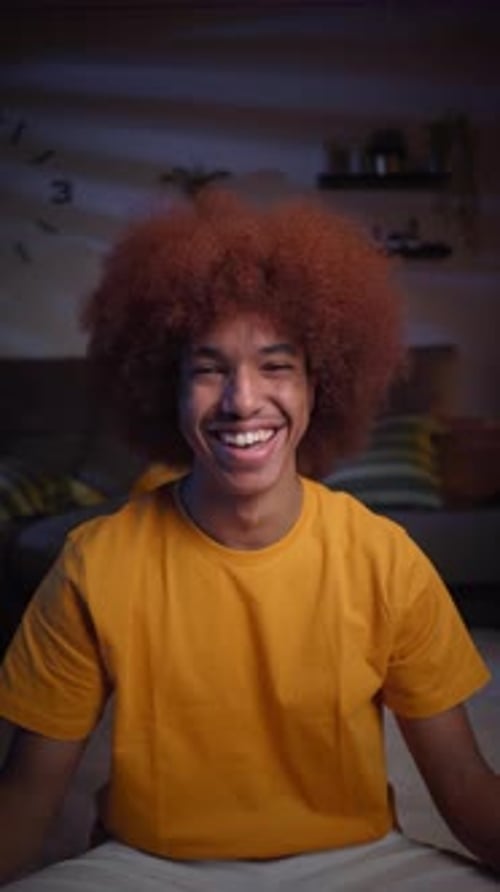 Young Adult Smiling Brightly Indoors at Night