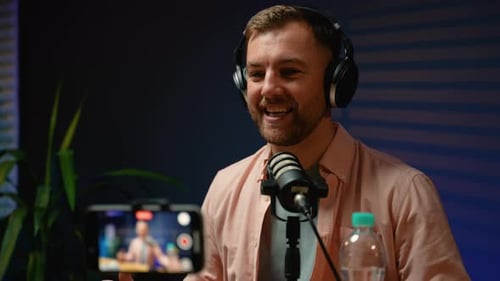 Man Speaking Into Microphone While Recording Podcast