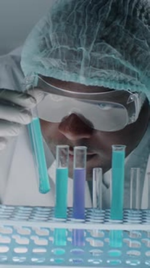 Scientist Works With Colorful Test Tubes in Laboratory