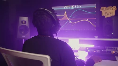 Black Man is Working in Modern Music Recording Studio Sound Engineer with Digital Audio Workstation