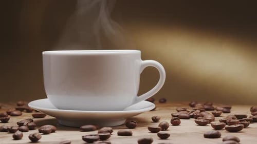 Steaming Coffee Cup with Coffee Beans Close Up