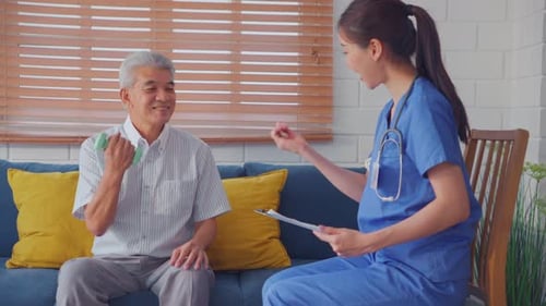 Senior Man Exercises with Nurse Supervising in Home