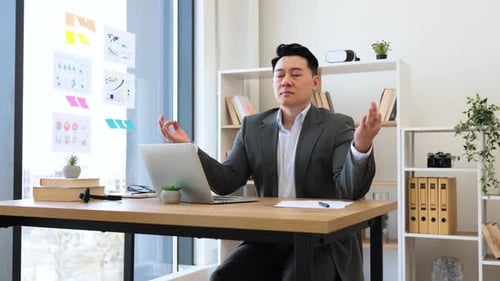 Businessman Practicing Mindfulness Meditation in Modern Office Space