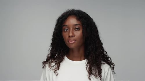 Woman Smiling in Studio with Curly Hair