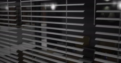Looking Through Blinds at a Quiet Modern Space in the Evening Light