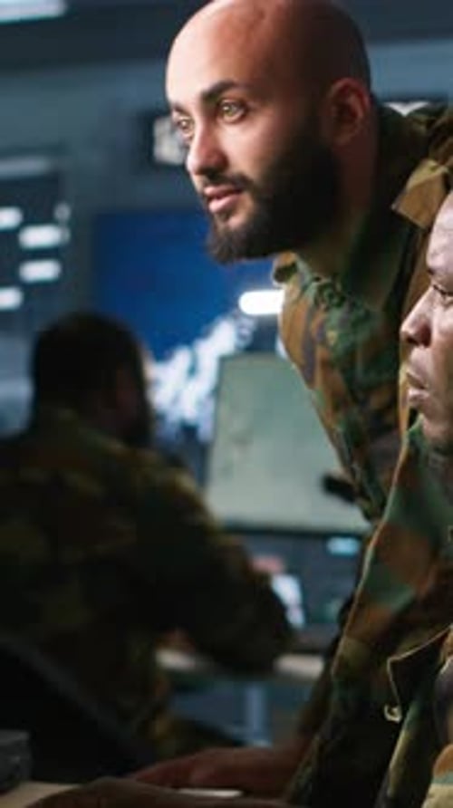 Soldiers Monitoring Computers in Military Office at Night