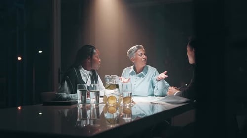 Night, people and discussion in boardroom with documents for teamwork, collaboration