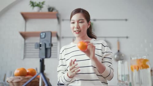 Beautiful asian content creator recording a video or live streaming