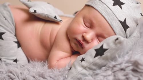 Peaceful Newborn Infant Sleeping Soundly in Soft Clothing