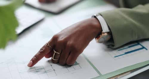 Hand Pointing at Business Data Charts