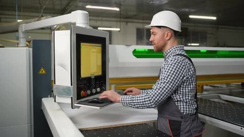 Operator Programs CNC Machine for Wood Panel Cutting