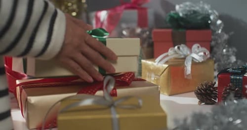 Close up of girl hands preparing present gift box winter christmas decorations on table. .