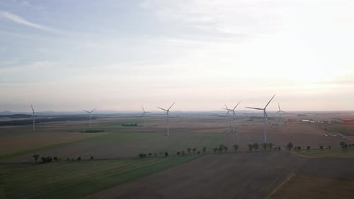 Windmill Turbine Generator Against Beautiful Sunset Sky in Countryside Area