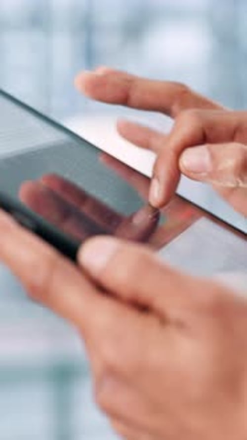 Hand Touching Tablet Screen at Work