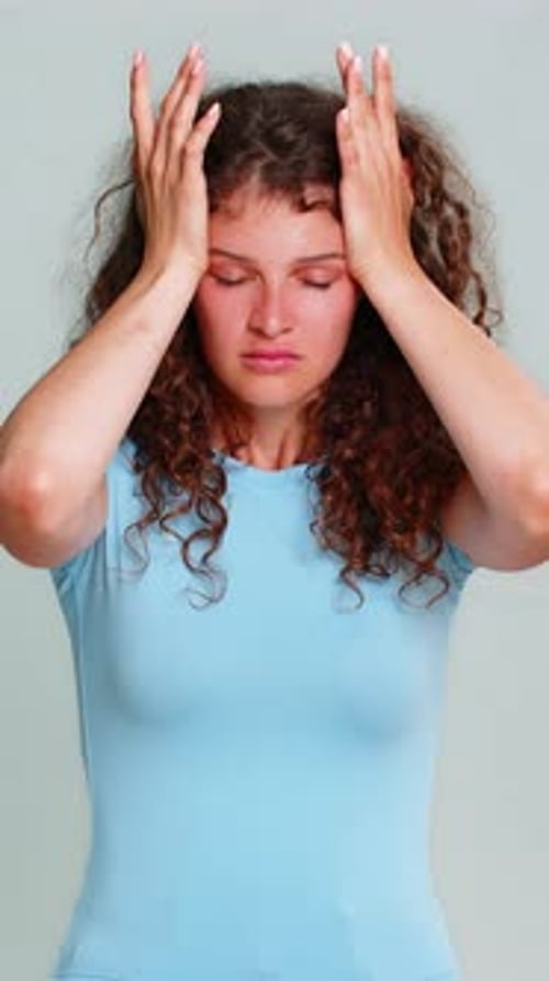 Woman Massaging Temples Experiencing Pain or Headache
