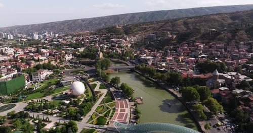 Aerial Pullback Reveals Rike Park, Bridge of Peace. Downtown Tbilisi, Georgia